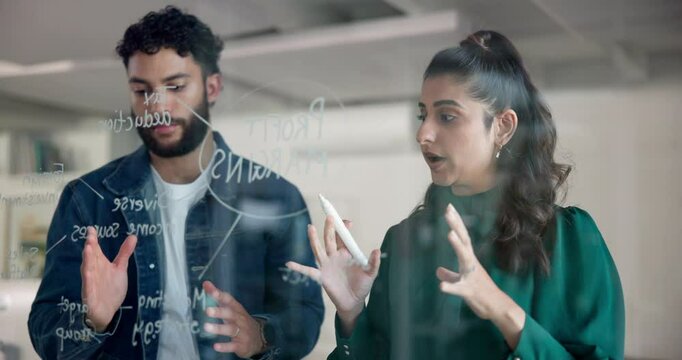 Business people, writing and planning with glass board for brainstorming, mindmap or profit margins. Businessman, woman or colleagues taking notes with graph, chart or schedule for ideas at workplace