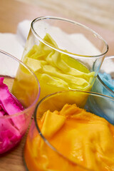 top view of glass flasks with dyed bright fabrics, background for needlework