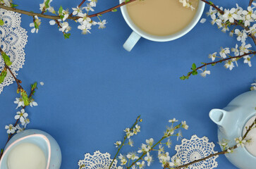 A frame with flowers, twigs, a cup of coffee, pots, handmade, retro doilies and empty place to fill...