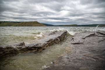 seascape with rocks against which waves crash