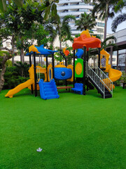 The colorful playground on yard in the park.