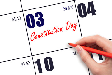 May 3. Hand writing text Constitution Day on calendar date. Save the date.