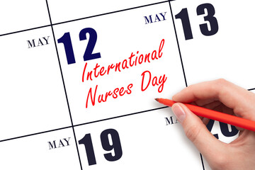 May 12. Hand writing text International Nurses Day on calendar date. Save the date.