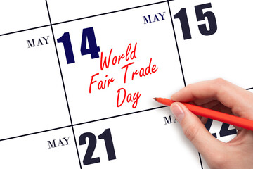 May 14. Hand writing text World Fair Trade Day on calendar date. Save the date.
