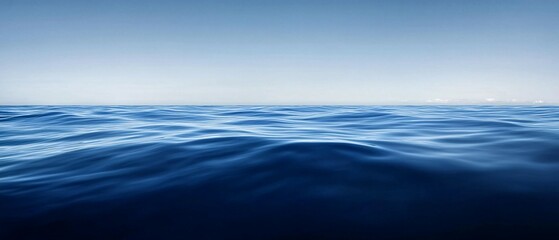 Ocean waves under a clear sky with a color gradient background.