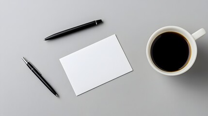 Blank business card mockup on neutral desk surface with coffee and pen