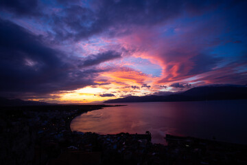 Sunset Over Coastal City and Sea in Greece