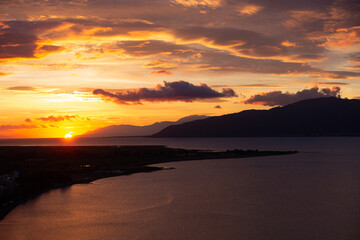 Sunset Over Coastal City and Sea in Greece