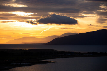 Sunset Over Coastal City and Sea in Greece