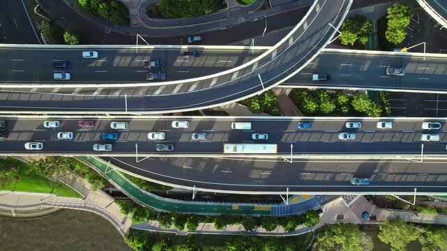 Top-down aerial footage of busy highways, interchanges, and overpasses showcasing vital urban transport arteries. Intense car movement highlights city connectivity.