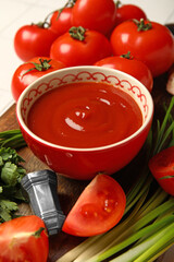Bowl with tasty ketchup on table, closeup