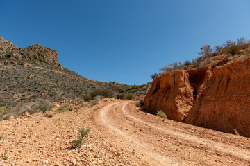 Beautiful scenery with winding gravel dirt road, Costa Blanca , Alicante, Spain - stock photo