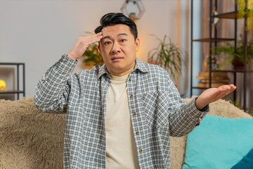 I dont know what to say. Confused Asian handsome man feeling embarrassed about ambiguous question,...