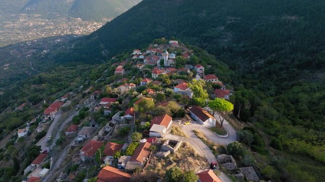 Slow panning drone shot of Exogi village in Ithaca island, Greece during sunset