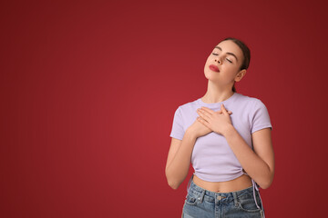 Beautiful young woman meditating on red background. Zen concept