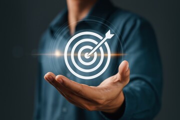 Person holding a in their hand, symbolizing goal setting, achievement, or focused ambitions in life