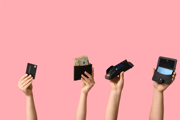 Female hands with credit cards, wallet and payment terminal on pink background