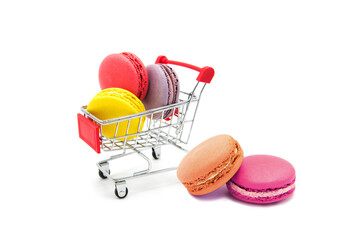 Shopping supermarket cart with colorful varied assortment macarons cookies isolated on a white...