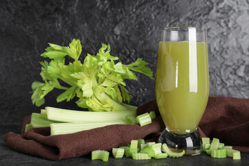 Bottle of celery juice with chopped and whole celery on black background