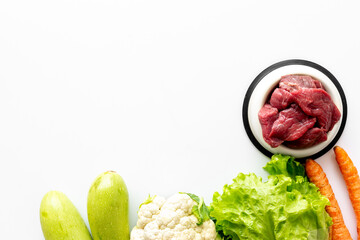 Bowls with healthy pet food and ingredients, top view