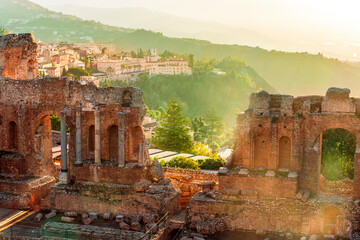 beautiful sunset landscape of evening ancient teatre  with cityscape and evening mopuntains on...