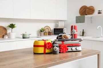 Different household appliances on counter as gift in kitchen