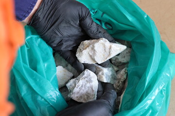 Mining of lithium. Sample of spodumene hard rock ore, examined by mine geologist. Processed into...