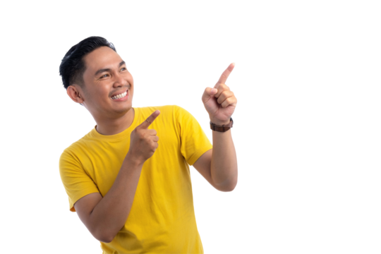 Portrait of excited handsome Asian man pointing finger at copy space for text advertisement isolated on transparent background