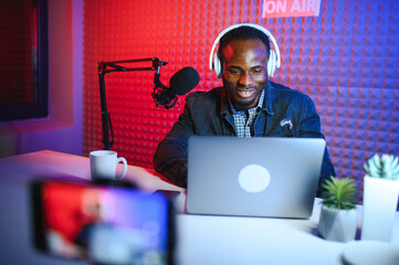 Handsome Young African American Man Talking Into Microphone While Recording Radio Show