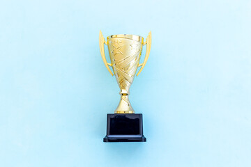 Award golden trophy cup as a symbol of victory. Winning the competition concept