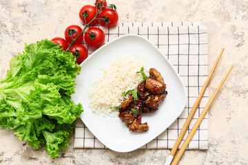 Tasty sweet and sour chicken with rice in plate, vegetables and chopsticks on beige grunge background