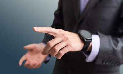 Businessman hand pressing an imaginary button on virtual screen