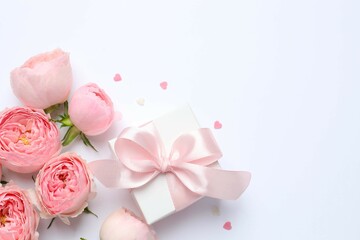 Beautiful pink peony roses with gift box on a цршеу background