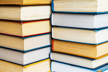 stack a large pile of printed books lies on the table, book covers and pages for study