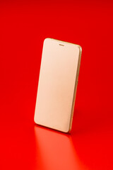 Golden Smartphone on Red Background