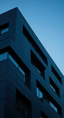 Modern Architecture: Striking Building Facade & Geometric Design Against a Serene Blue Sky - Urban Design, Contemporary Style