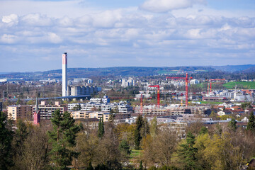 Scenic view of landscape with skyline of Swiss City of Zürich in the background on a sunny spring day. Photo taken April 1st, 2025, Zurich Schwamendingen, Switzerland.