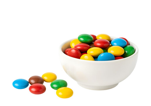 Colorful candies in bowl isolated on white background