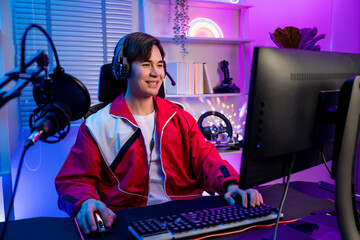 Asian young esport male gamer playing online video game on computer.  © Kawee