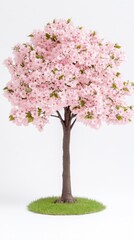 Obraz premium A delicate pink cherry blossom tree in full bloom stands elegantly on a small patch of green grass against a clean white background showcasing its exquisite beauty.