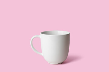 White ceramic empty mug on pink background