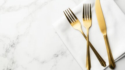 Gold cutlery on white napkin, marble background, elegant dining