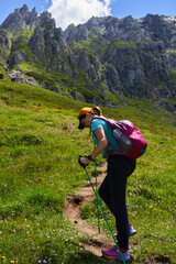 Woman hiking on alpine trail.........