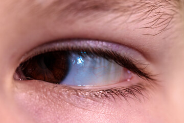 Obraz premium brown eye of teenager looking towards boy close up