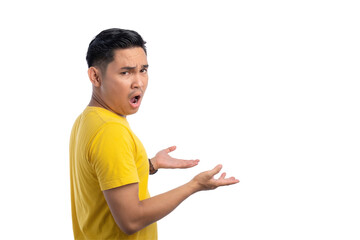 Shocked young Asian man looking confused while raising his hands and turning his head back isolated...