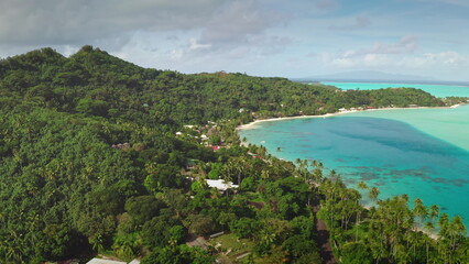 Obraz premium Drone footage revealing breathtaking tropical island beauty with lush greenery, pristine turquoise waters, sandy beaches, and swaying palm trees for a serene getaway