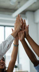 Obraz premium Teamwork Triumphs: Diverse Hands United in a High Five Celebration of Success and Collaboration in a Modern Office Space.