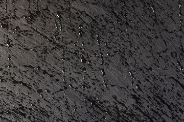 wet slate that is used for the background, droplets natural stone black slate is used for decorative purposes, close up