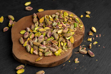 pistachios, chopped and crushed into pieces of different sizes, a bunch of green crunchy pistachios cooked with salt for beer