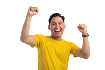 Excited handsome Asian man doing winner gesture with arms raised, shouting, celebrating success isolated on transparent background